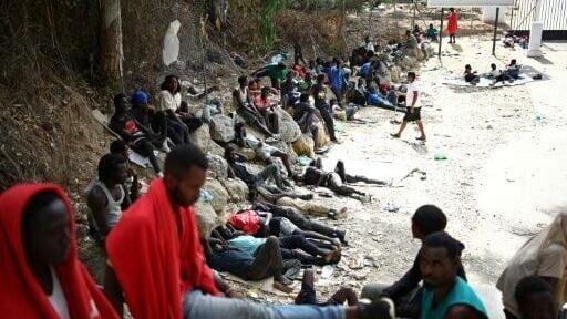Crowds of migrants - pictured here on August 1, 2026 - slept rough outside Ceuta's full migrant centre