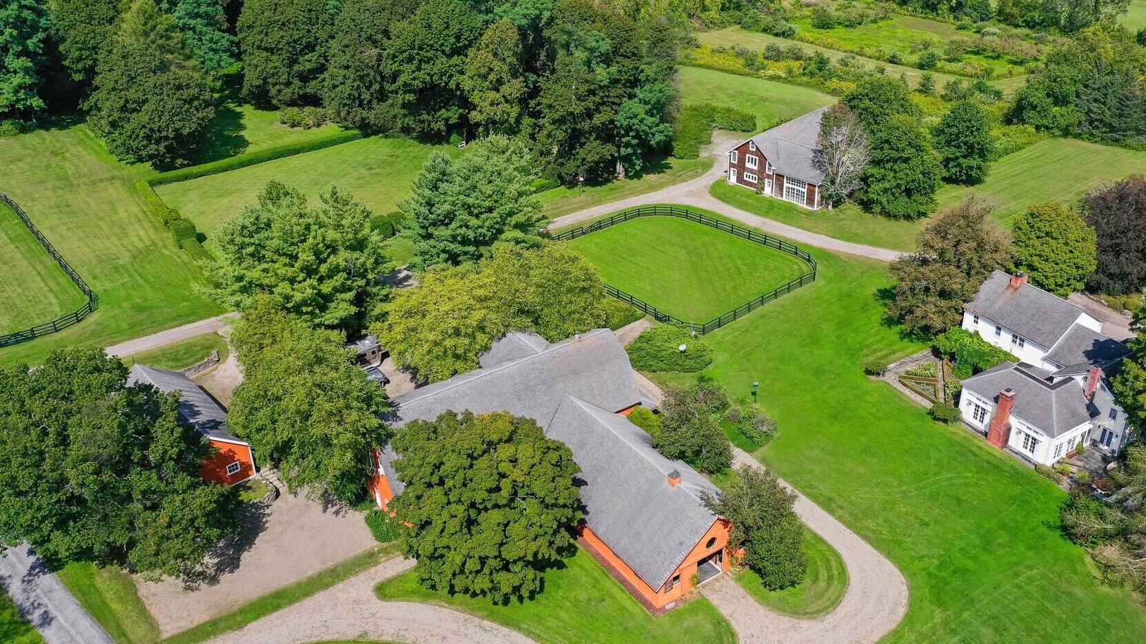 In addition to manicured grounds that include multiple paddocks, a private pond, gently rolling hills and sweeping views of the Catskill Mountains, the property includes a main residence (at right), 10-stall barn with upper-level apartments (center), ca...