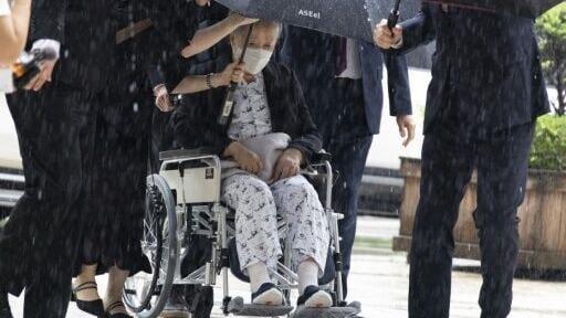Unification Church leader Han Hak-ja (in wheelchair) arrives for the sentencing at the Seoul Central District Court