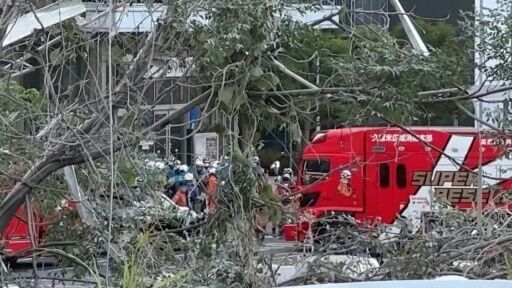 Rescue workers outside the damaged Aeon Mall Kumamoto shopping center in southwestern Japan following a major earthquake.