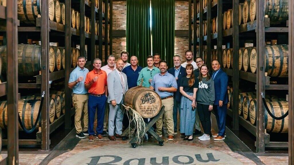 Bayou  and Crescent Crown Distributing teams at Louisiana distillery