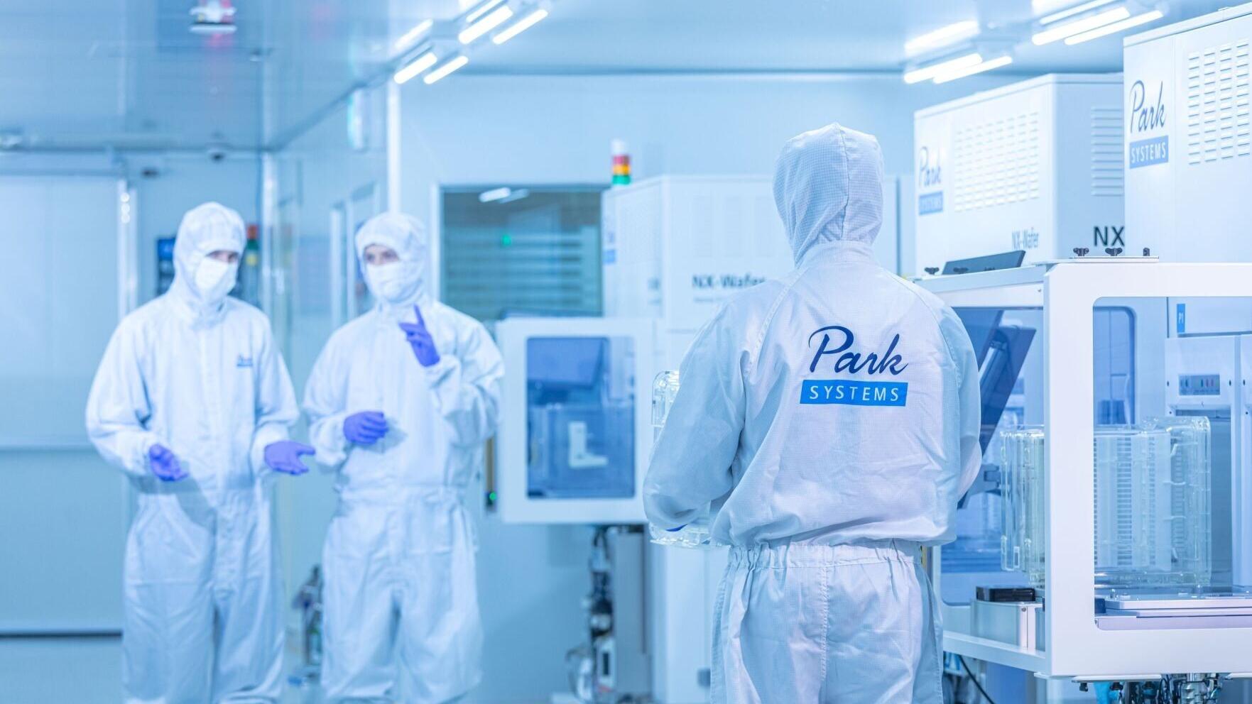 Engineers operating Park Systems metrology solutions in a semiconductor cleanroom environment.