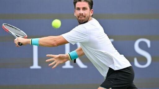 Britain's Cameron Norrie makes a backhand return in a victory over Australian third seed Alex de Minaur to reach the fourth round of the ATP Montreal Masters
