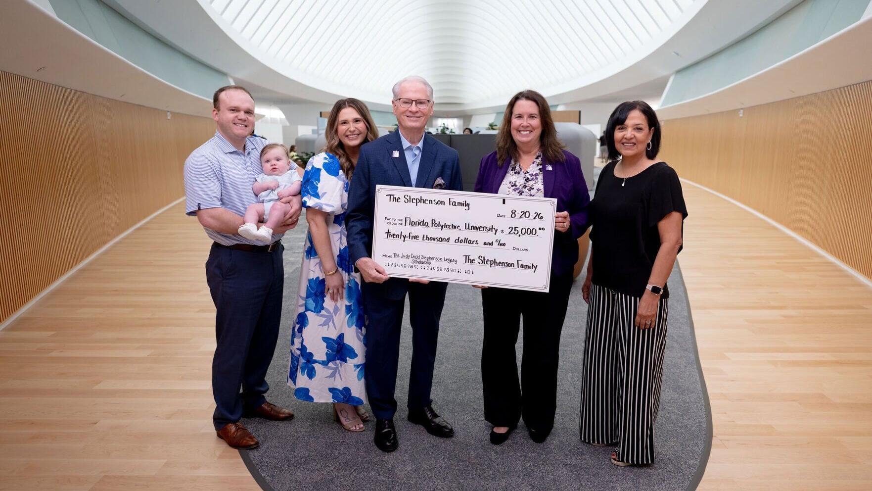 Dr. Devin Stephenson, center, president of Florida Polytechnic University, presents a $25,000 check to Kelli Stargel, vice president for strategic initiatives, development and external relations. To the left are Stephenson’s son-in-law Cody Earl Bittle,...