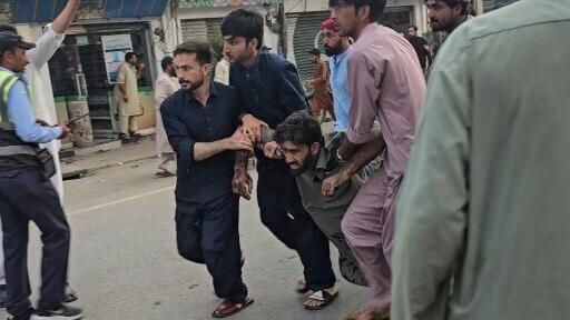A suicide bomber killed 13 people and wounded 22 in an attack near a police station during a protest in northern Pakistan's Swat district, police said