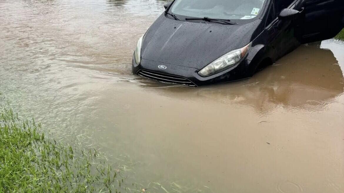 vehicle stuck in flooded ditch