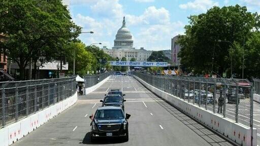 US President Donald Trump rides in the armored presidential limousine, known as "The Beast," on the 1.7-mile Washington street course ahead of the start of the IndyCar Freedom 250 Grand Prix