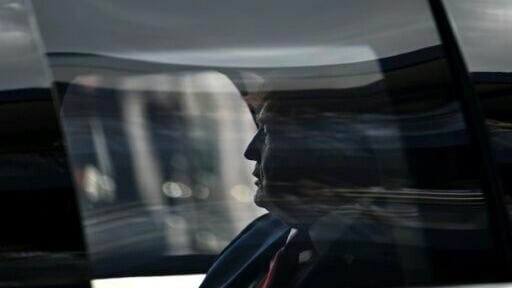 US President Donald Trump rides in the presidential limousine, known as "The Beast," on the track prior to the start of the IndyCar Freedom 250 Grand Prix in Washington