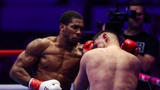 Britain's Anthony Joshua (L) and Albania's Kristian Prenga trade blows during their heavyweight boxing fight in Jeddah