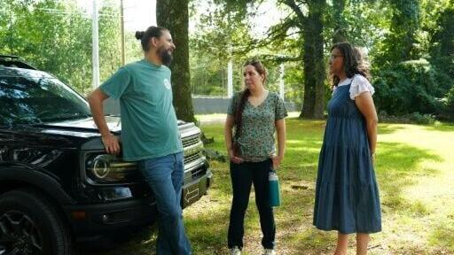 Residents Jason Haley, Shannon Samsa and Krystal Polk talking outside Polk’s home located close to the power generation facility of SpaceXAI’s Colossus II data center in Southaven, Mississippi