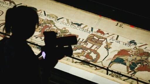 A camera operator videos a section of the Bayeux Tapestry during the press preview at the British Museum in London