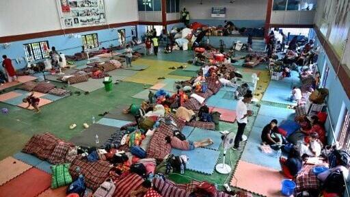 Flash flood survivors rest inside a relief shelter at Devighat in Nepal's Nuwakot district on September 6, 2026. Sheltering with relatives or in temporary camps, survivors of devastating floods in Nepal say they can no longer rebuild their homes after t...