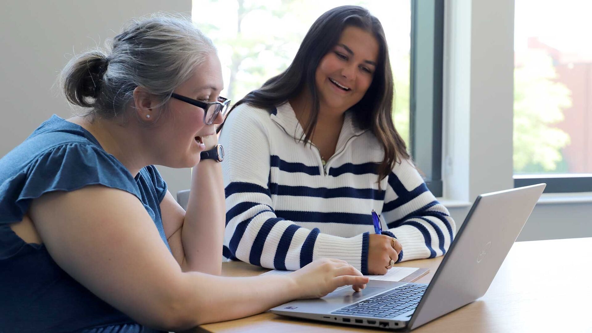 Auburn College of Education faculty member Jennie Baumann works with a student inside Auburn's new College of Education Building.