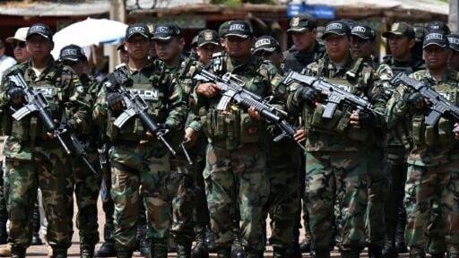 Bolivian police from a special drug task force stand guard as President Rodrigo Paz announces a plan to boost security along the border with Brazil
