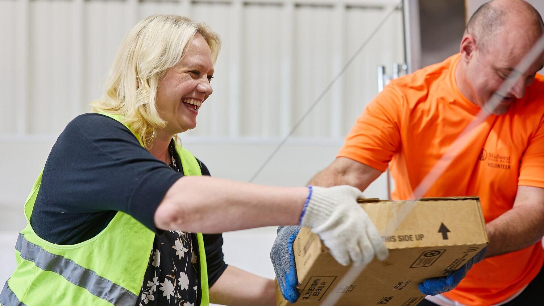 Caterpillar employee sorting boxes at Midwest Food Bank in Peoria, IL.