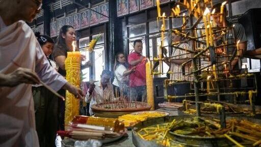People light candles to mark the start of Buddhist Lent at Wat Nong Song Hong Buddhist temple in Samut Sakhon province on July 30, 2026