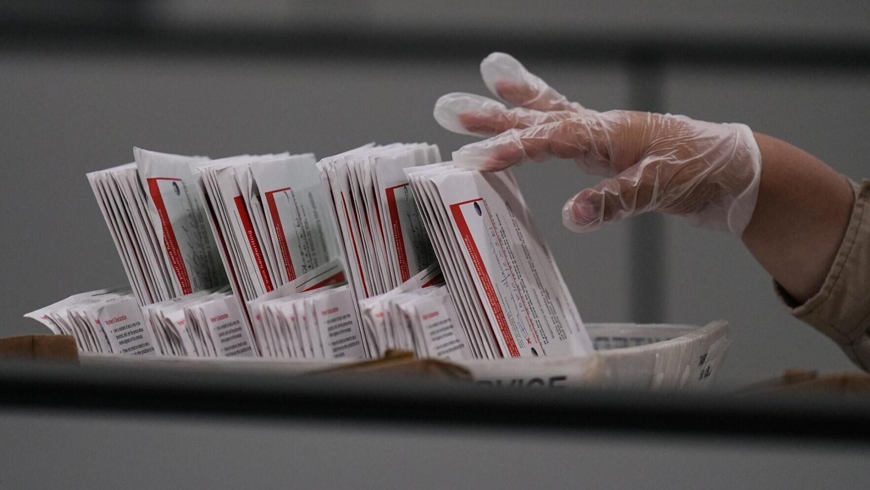 A worker inspects a ballot the day after California's primary election at the Los Angeles County Ballot Processing Center on June 3, 2026.