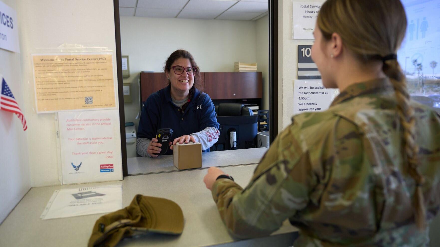 AbilityOne employees including Amy Yackinan of Catholic Community Services of Southern Arizona deliver mail to members of the U.S. military