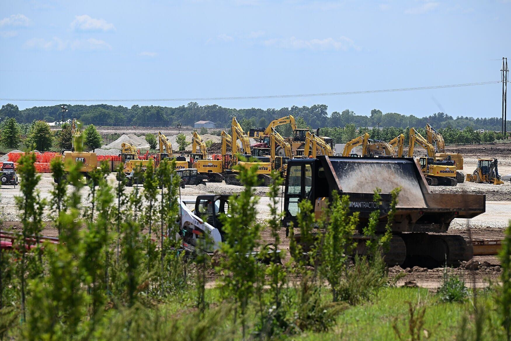 An army of large excavators and earth moving equipment