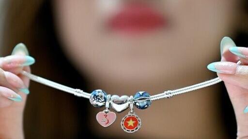 Pandora opened its first Vietnam plant by showing off bracelet charms featuring the country's national flag and a bowl of pho noodle soup