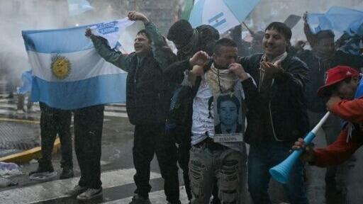 Demonstrators braved rough weather to demand changes to property laws being considered by the Senate, gathering outside the National Congress in Buenos Aires