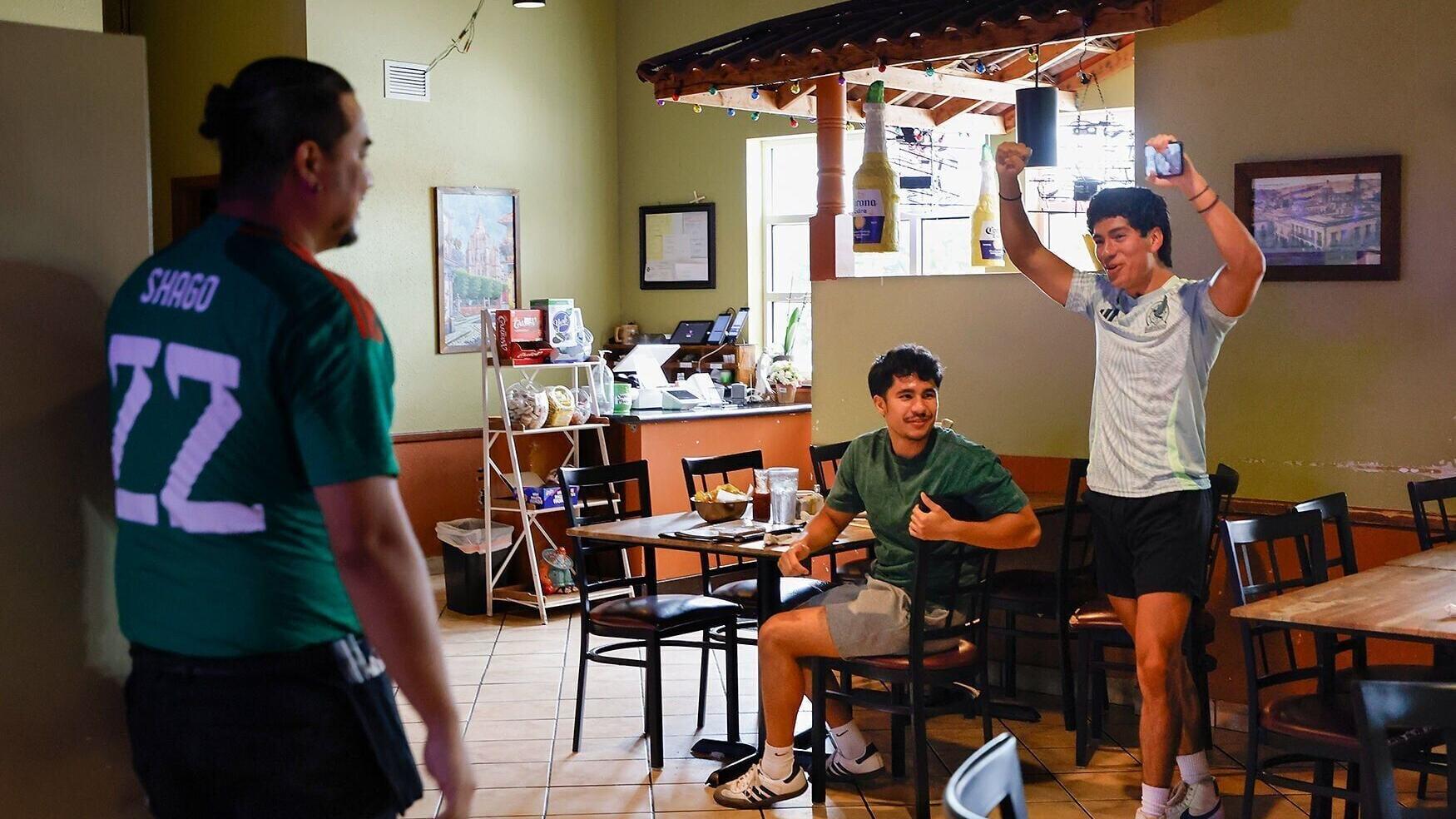 braham Ramirez, right, and Donovan Metz, center, celebrate