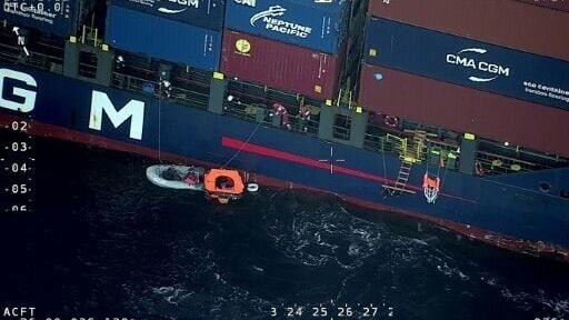 A 143-metre (470-foot) container ship rescued four sailors after their yacht collided with a sperm whale