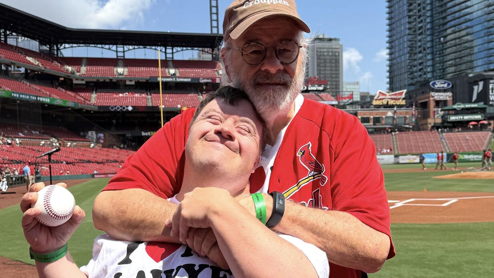 Brown &amp; Crouppen Founding Partner Terry Crouppen with Special Olympics athlete David Kime following David’s ceremonial first pitch, made possible through Brown &amp; Crouppen’s partnership with the St. Louis Cardinals and the Gateway Down Syndrome Association.