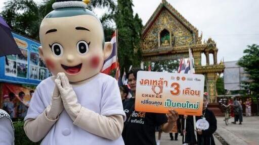 A mascot takes part in a parade to encourage people to abstain from drinking alcohol for three months at the start of Buddhist Lent