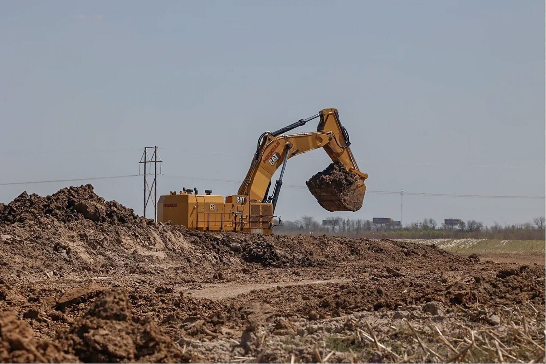 An excavator works at the Google data center site at the I-70 and Highway 19 interchange