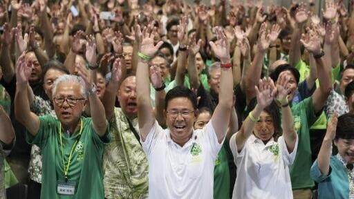 Genta Koja (front centre) celebrates with his supporters after winning the Okinawa gubernatorial election in Naha, Okinawa