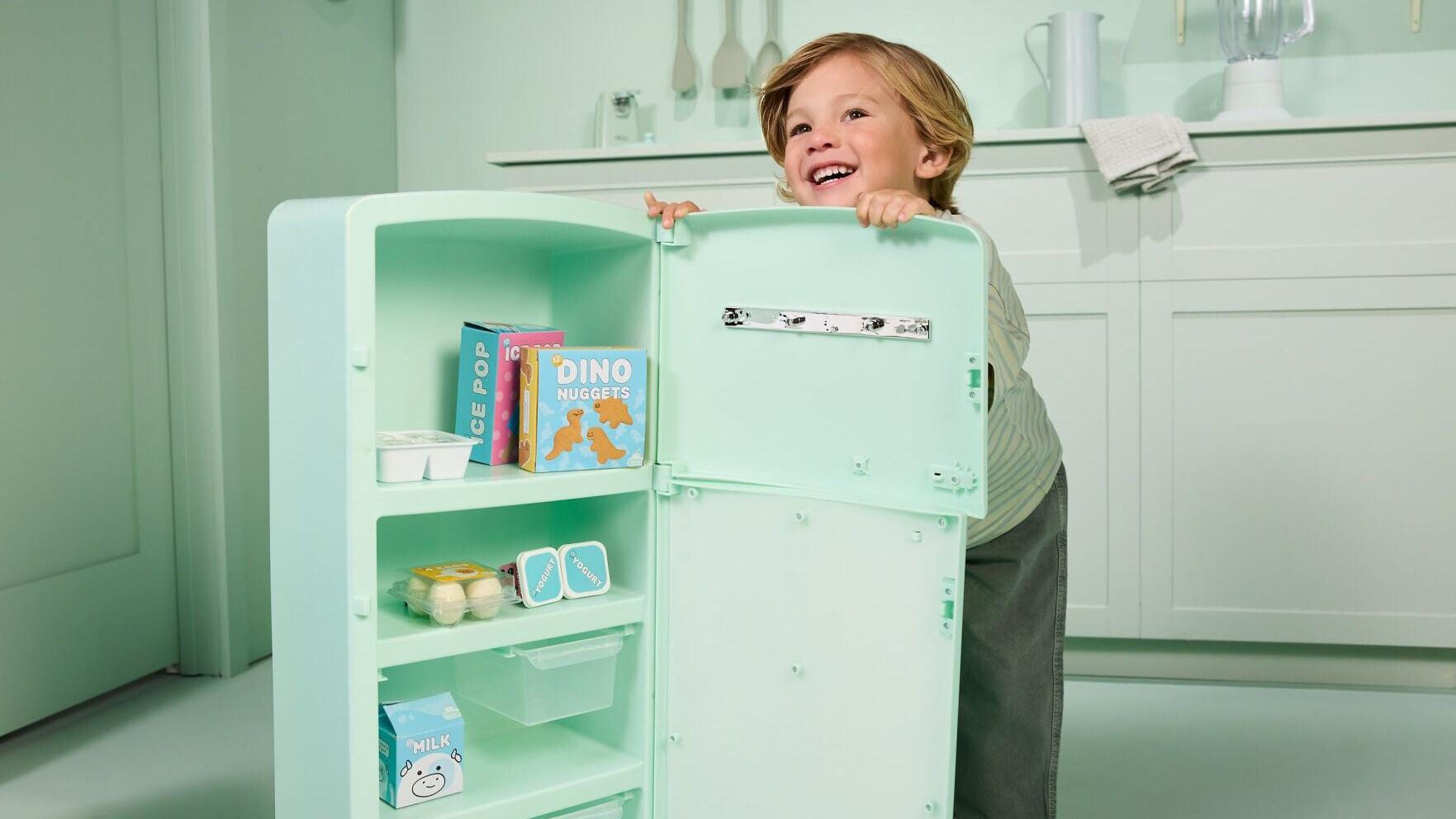 Modular Kitchen Refrigerator, a vintage inspired role-play refrigerator that invites little ones to stock, sort and pretend with a dedicated fridge and freezer of their own and includes 20 food accessories.