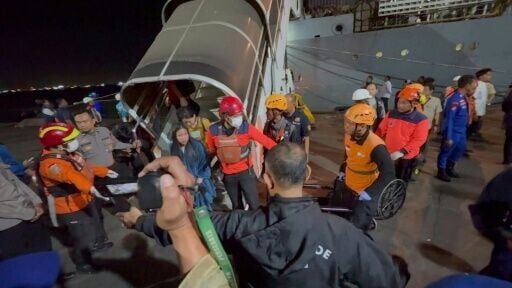 Rescued receive treatment after Indonesian ferry catches fire at sea