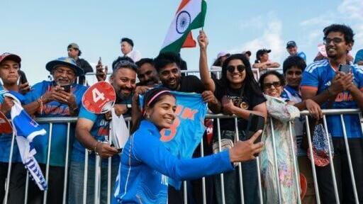 India's Shreyanka Patil poses with supporters after their victory in the women's gold medal cricket match