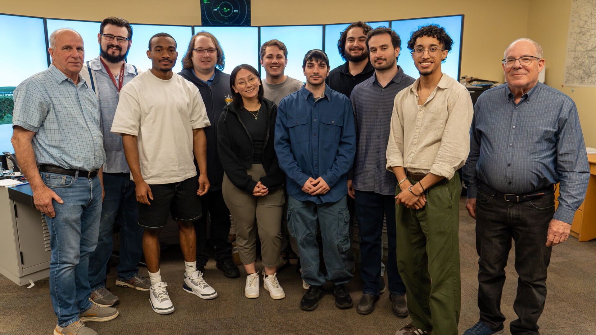Group photo of the Enhanced Air Traffic-Collegiate Training Initiative Vaughn graduates who passed, along with two Vaughn College air traffic control adjunct instructors.
