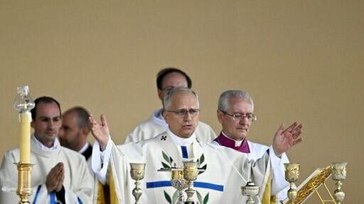 The pope's prayers were accompanied by choir and organ music as the sun broke through the grey skies