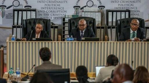 The three-person panel is headed by former Constitutional Court judge Mbuyiseli Madlanga (centre) and sits in the capital, Pretoria
